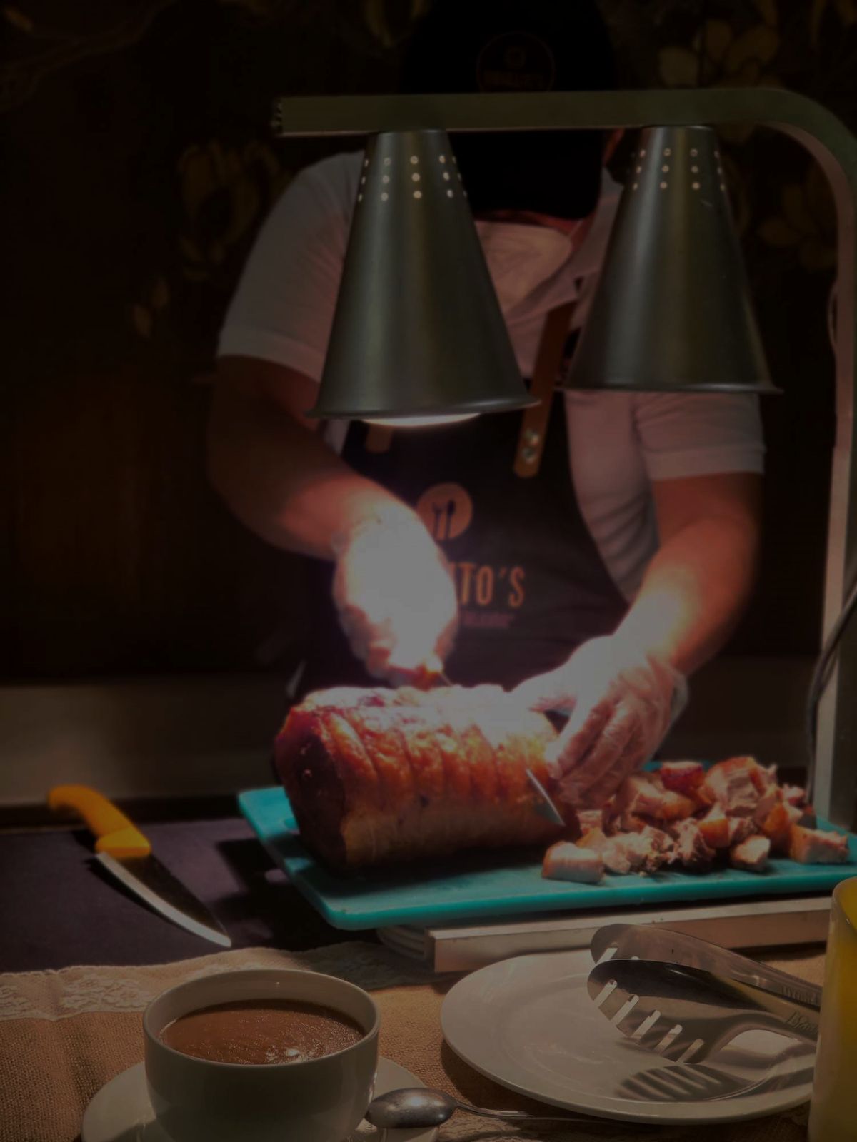 Chef carving herb roast beef at a live station